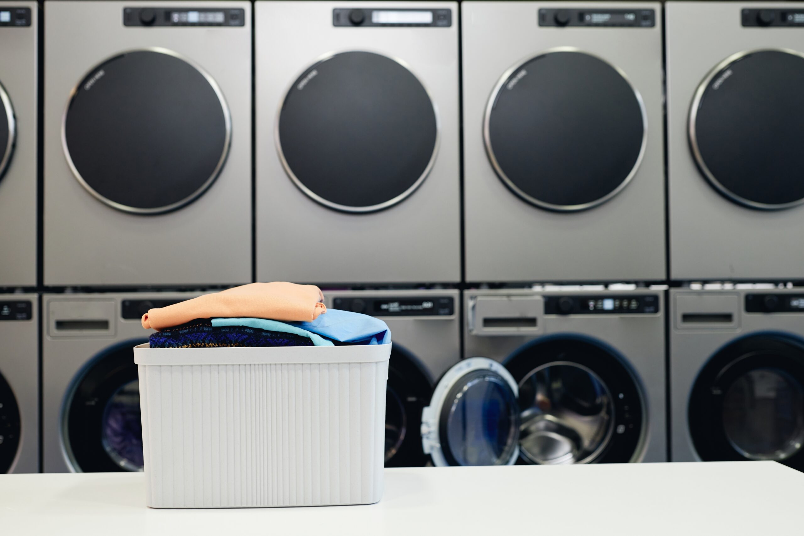 Background,Shot,Of,Basket,Full,Of,Colored,Clothes,On,Folding